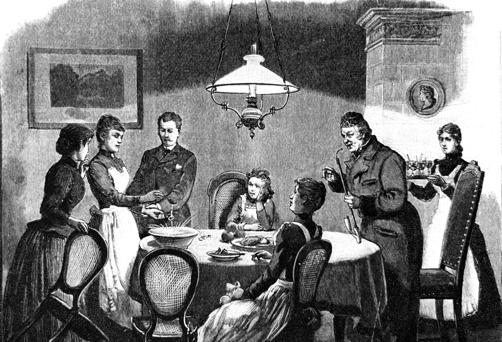 An image of a family gathered around a table for a meal.