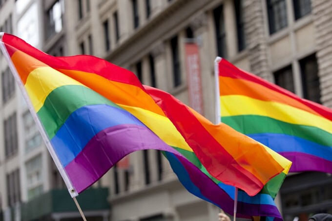 Gay pride rainbow flags waving in the air