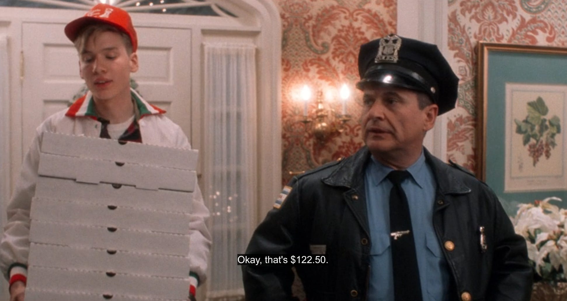 A pizza delivery guy holds a pile of pizza boxes that costs $122.50 in the 1990 holiday movie Home Alone.